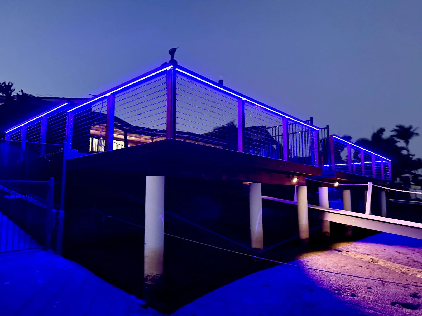 Feature LED strip lighting installed along a waterfront deck handrail by KBR Electrical