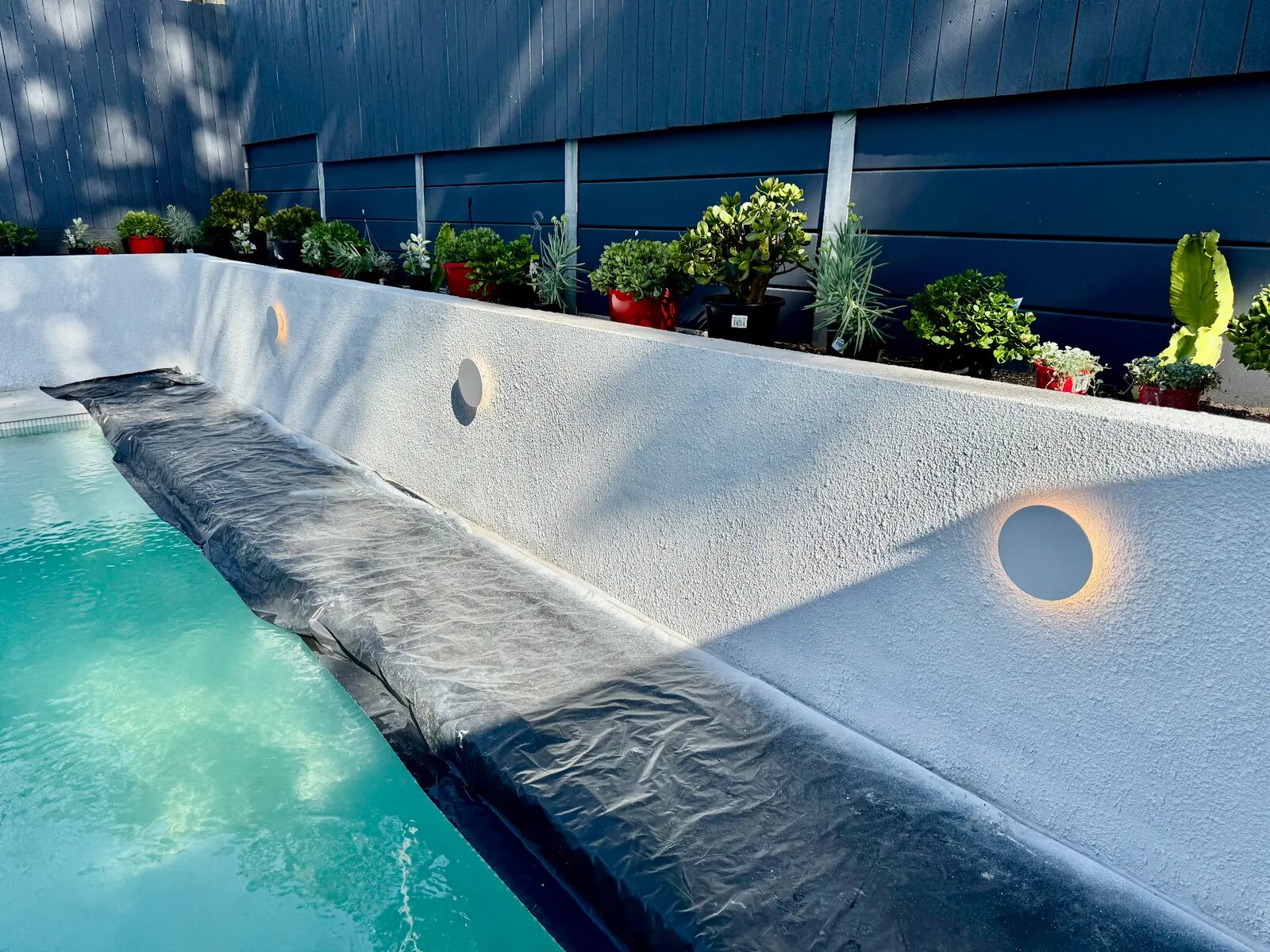 Recessed wall lights installed along a pool surround by KBR Electrical